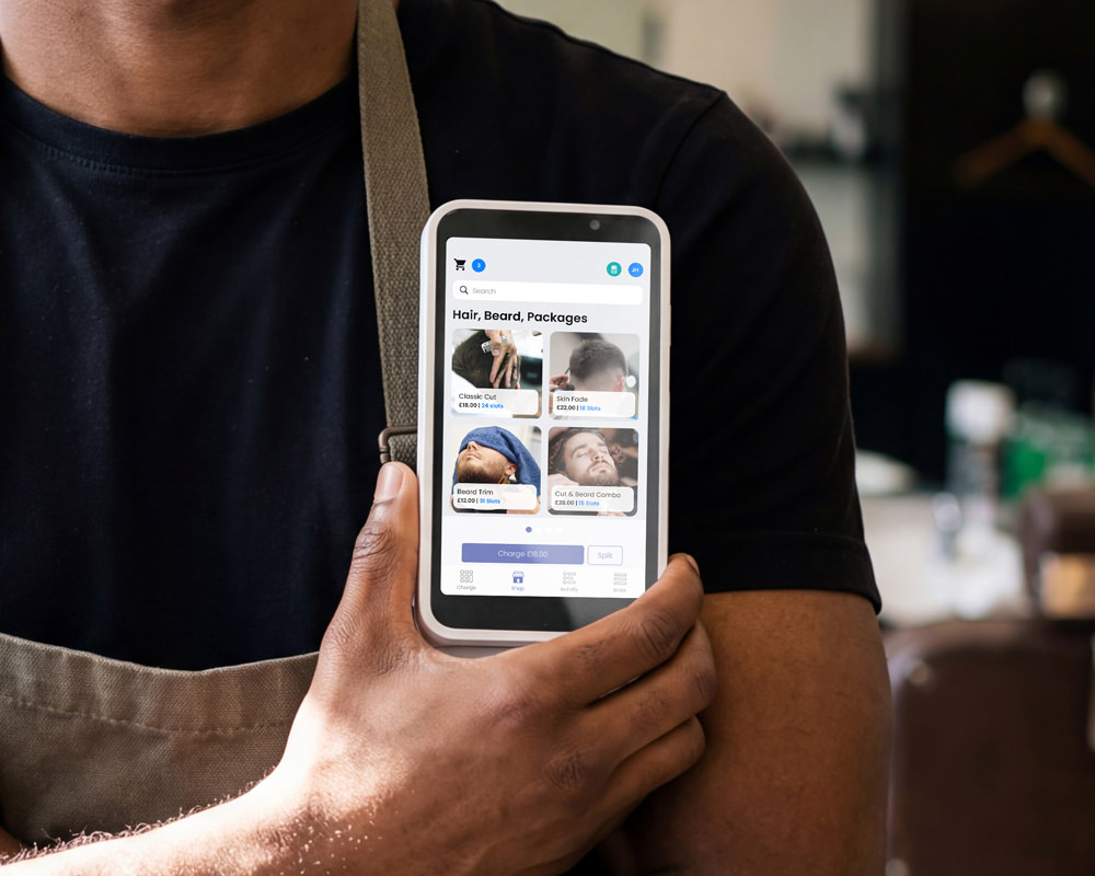 Barber holding phone with Lopay Point of Sale